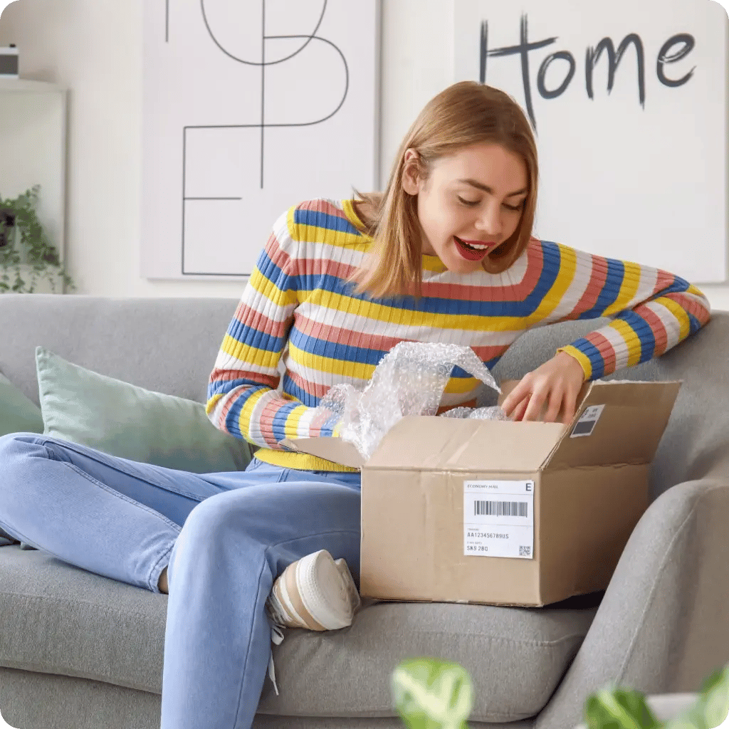 happy woman opening parcel