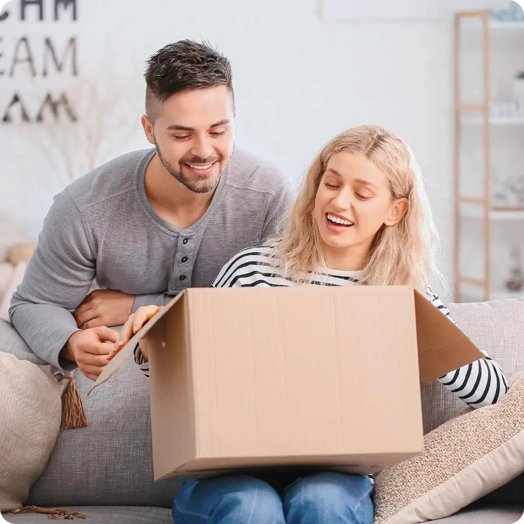 A young couple opening a parcel A young couple opening a parcel